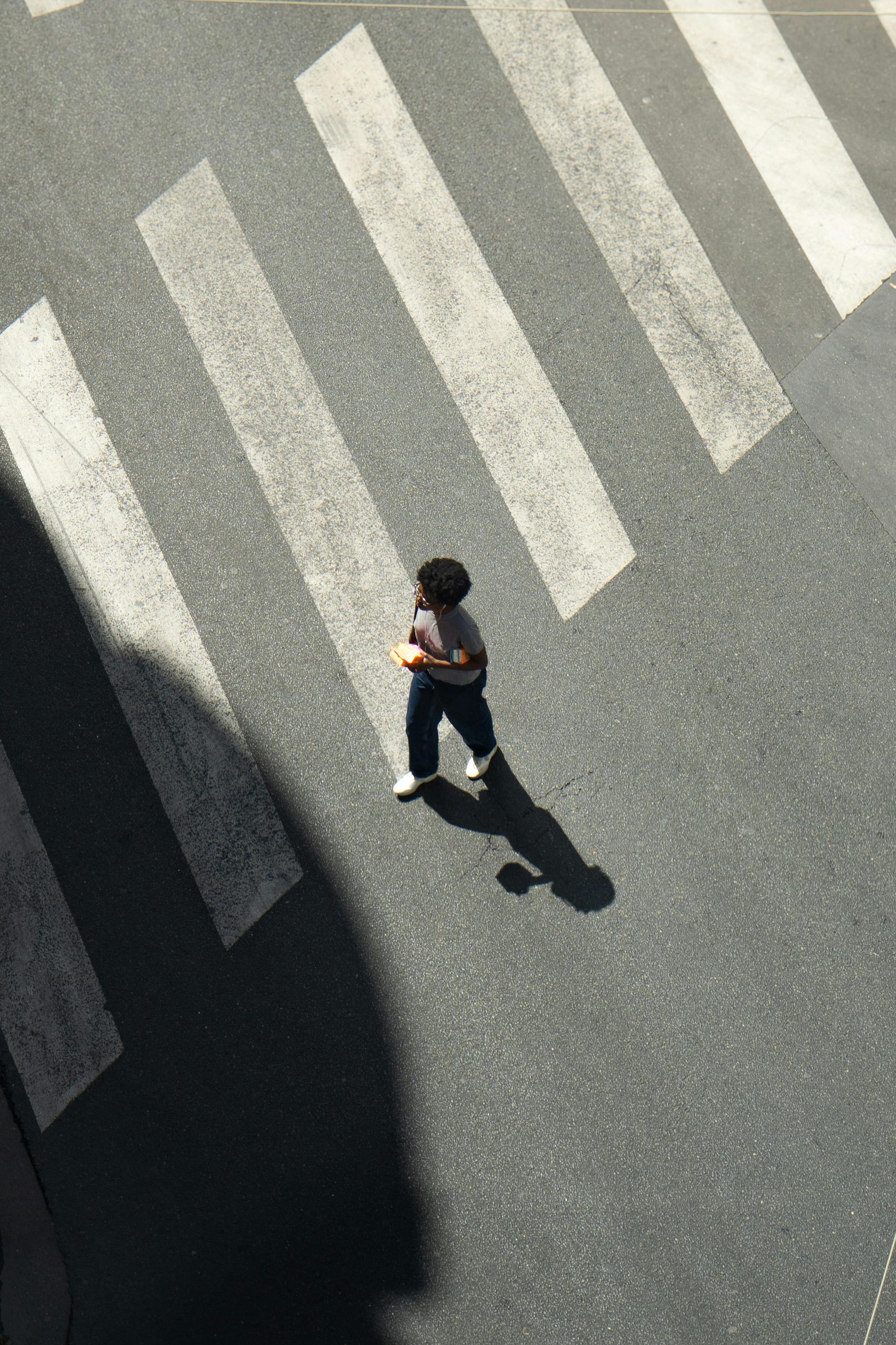 Person crossing a zebra crossing seen from above